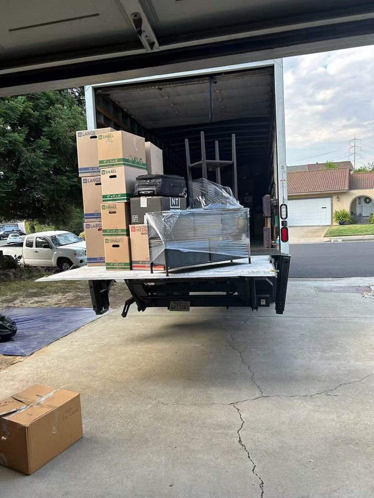 K-Line Movers loading a truck with boxes and furniture